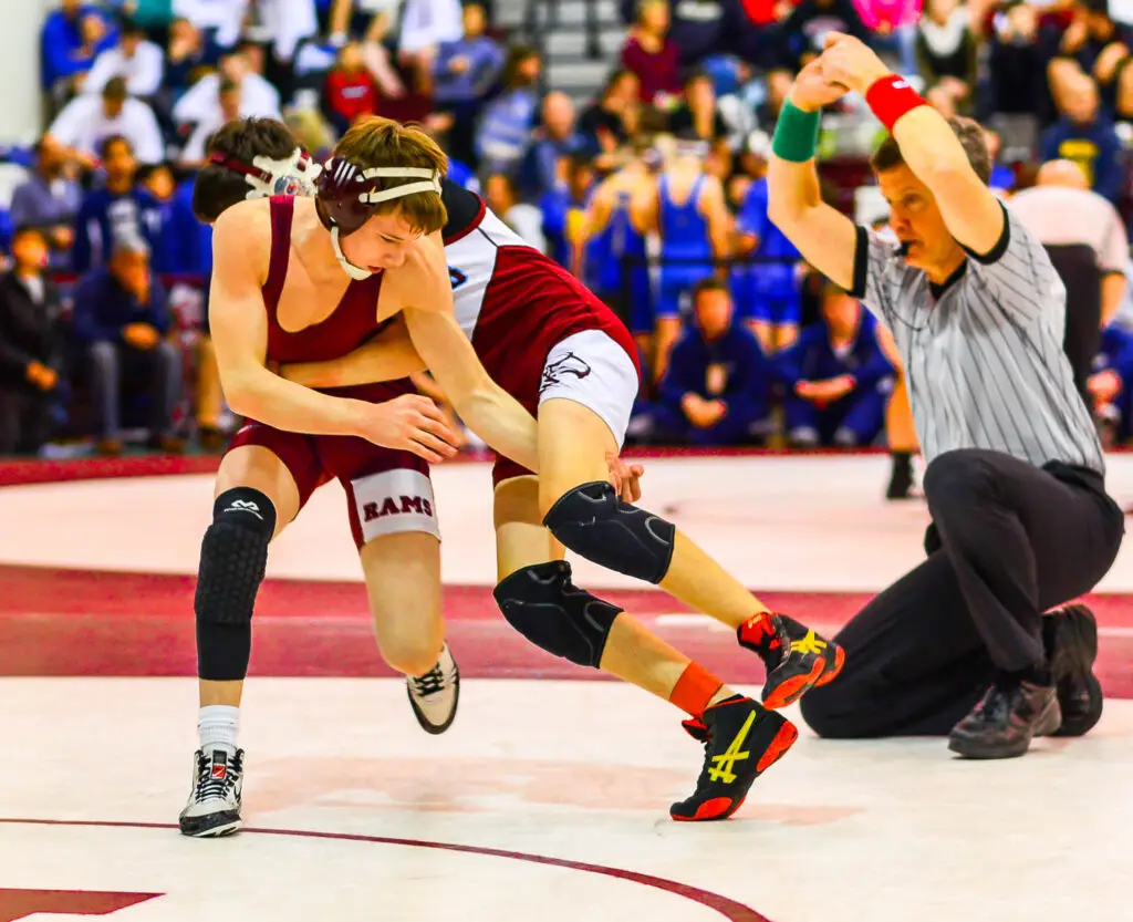 Andrew Fallon executing a standing switch for a reversal during a high school wrestling match as a freshman
