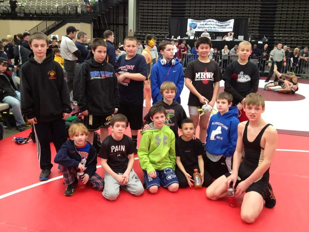 Youth wrestlers from Team New England pose together at a wrestling tournament