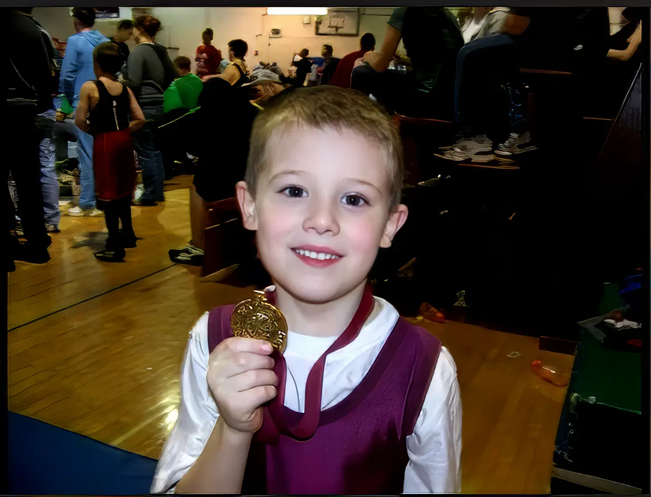 Young wrestler in a Warren Wrestling Club singlet at a youth wrestling event