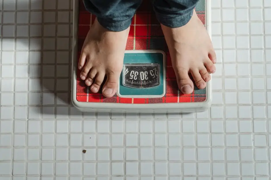 Child standing on a bathroom scale at home to check weight before a youth wrestling tournament